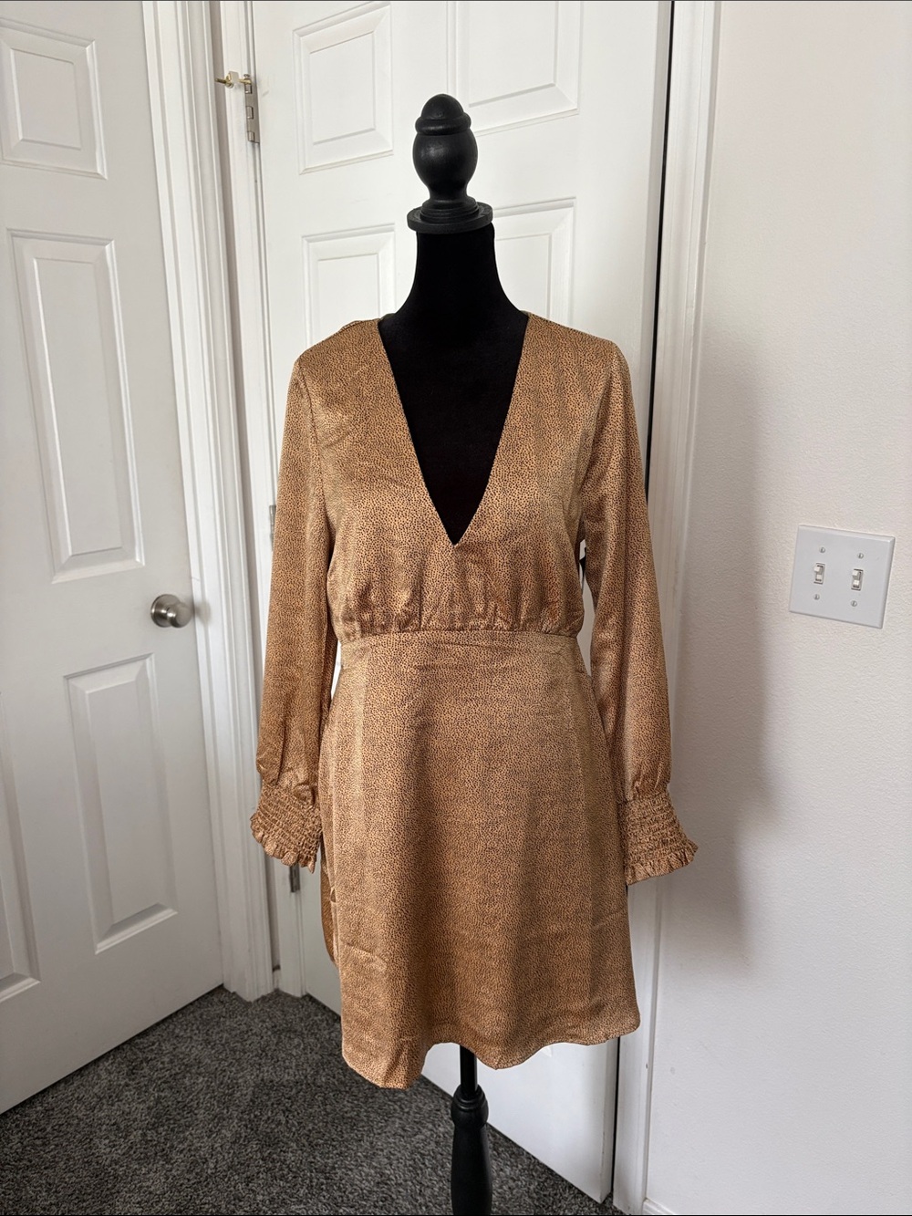 Francesca’s Mi Ami Gold and Black Dotted Mini Dress.